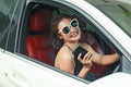 Young woman driving the car and talking phone on the road Royalty Free Stock Photo