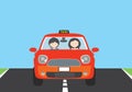 A young woman driving a red car with a passenger and a TAXI sign Royalty Free Stock Photo