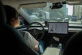 Young woman driving Tesla, Shenzhen China.