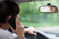 Young woman driving and using cell phone Royalty Free Stock Photo