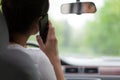 Young woman driving and using cell phone Royalty Free Stock Photo