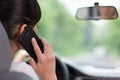 Young woman driving and using cell phone Royalty Free Stock Photo