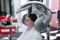 A young woman is drying her hair in a beauty salon. The concept of beauty and health. Special equipment for drying hair. Royalty Free Stock Photo