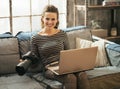 Young woman with dslr photo camera using laptop Royalty Free Stock Photo