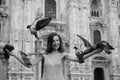 Young woman on Duomo di Milano Cathedral. Happy tourist in front of Duomo cathedral, Milan. Girl traveling in Italy. Royalty Free Stock Photo