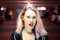 Young woman with dyed hair sticking out tongue Royalty Free Stock Photo