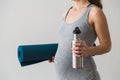 Young woman in early pregnancy going to an exercise class