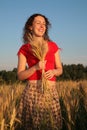 Young woman with earns on wheaten field Royalty Free Stock Photo