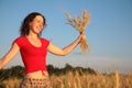 Young woman with earns on wheaten field Royalty Free Stock Photo