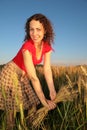 Young woman with earns on wheaten field Royalty Free Stock Photo