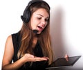 Young woman in earphones and microphone with tablet, isolated Royalty Free Stock Photo