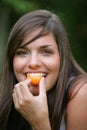 Young woman eating apricots