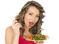 Young Woman Eating an Aromatic Rainbow Asian Style Salad Royalty Free Stock Photo