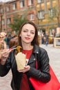 Young Woman Eating Asian Take Out At Busy Festival