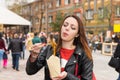 Young Woman Eating Asian Take Out at Busy Festival Royalty Free Stock Photo