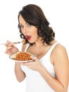 Young Woman Eating Baked Beans on Toast