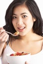 Young Woman Eating Bowl Of Cereal In Studio Royalty Free Stock Photo