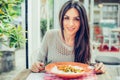 Young woman eating chinese food in a restaurant, having her lunch break