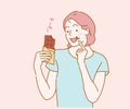 Young woman eating chocolate bar. Hand drawn