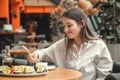 Young Woman eating and enjoying fresh sushi Royalty Free Stock Photo