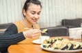 Young Woman eating and enjoying fresh sushi Royalty Free Stock Photo