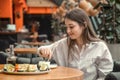 Young Woman eating and enjoying fresh sushi Royalty Free Stock Photo