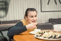 Young Woman eating and enjoying fresh sushi Royalty Free Stock Photo