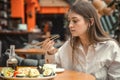 Young Woman eating and enjoying fresh sushi Royalty Free Stock Photo