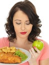 Young Woman Eating Fish and Chips with Mushy Peas Royalty Free Stock Photo
