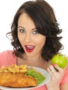 Young Woman Eating Fish and Chips with Mushy Peas Royalty Free Stock Photo