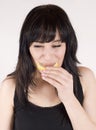 Young woman is eating fresh citrus fruit Royalty Free Stock Photo