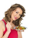 Young Woman Eating a Fresh Crispy Garden Salad Royalty Free Stock Photo