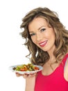 Young Woman Eating a Fresh Crispy Garden Salad Royalty Free Stock Photo