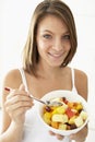 Young Woman Eating Fresh Fruit Salad Royalty Free Stock Photo