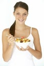 Young Woman Eating Fresh Fruit Salad