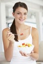 Young Woman Eating Fresh Fruit Salad Royalty Free Stock Photo