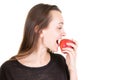 Young woman eating fresh red apple in closeup on copy space white background Royalty Free Stock Photo