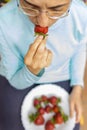 Young woman eating a fresh red strawberries Royalty Free Stock Photo