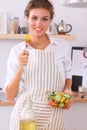 Young woman eating fresh salad in modern kitchen Royalty Free Stock Photo