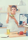 Young woman eating fresh salad in modern kitchen Royalty Free Stock Photo