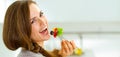 Young woman eating fresh salad in modern kitchen Royalty Free Stock Photo