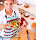 Young woman eating fresh salad in modern kitchen Royalty Free Stock Photo