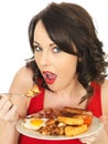 Young Woman Eating a Full English Breakfast Royalty Free Stock Photo