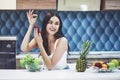 Young woman eating healthy salad with cherry tomatoes in the kitchen after a fitness session Royalty Free Stock Photo