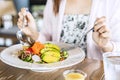 Young woman eating healthy salad at restuarant, Healthy lifestyle