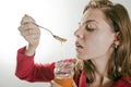 Young woman eating honey