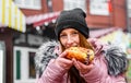 Young Woman Eating Hot dog. Street food outdoor Royalty Free Stock Photo