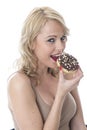 Young Woman Eating Iced Donuts