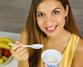 Young woman eating light Greek yogurt at home. Close up from above. Healthy concept Royalty Free Stock Photo