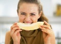 Young woman eating melon in kitchen Royalty Free Stock Photo